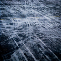 Icy wheel tracks on the black tarmac at Ilulissat airport in west Greenland