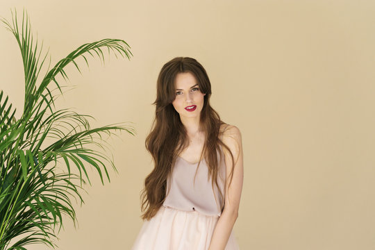 portrait of beautiful young woman on beige background