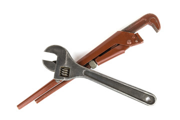 Adjustable red vintage gas pipe wrench and adjustable wrench, lying crosswise, isolated on white background, close-up