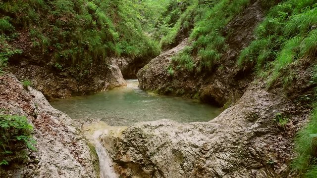 
Aerial view of small waterfalls surrounded by a lot of vegetation in Soca rivera.