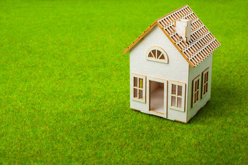 White small house on green grass