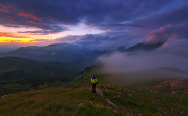 Climber among the foggy mountains