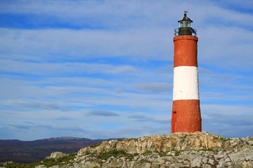 Red and white colored lighthouse on a small island in the Beagle channel, Ushuaia, Tierra del...