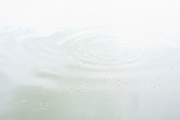 Surface water distribute into circular waves and bubble.
