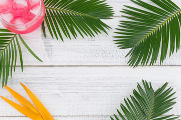 Watermelon fresh drink decorate with fern leaves and bird of paradise on white wood background,...