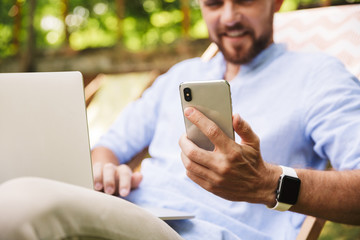Cropped image of happy young bearded man