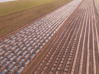 Agricultural landscape, aerial shot of an arable crop field. Arable land is the land under temporary agricultural crops capable of being ploughed and used to grow crops.