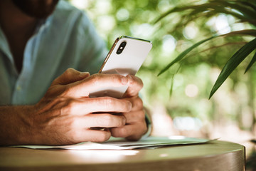 Cropped photo of man using mobile phone..