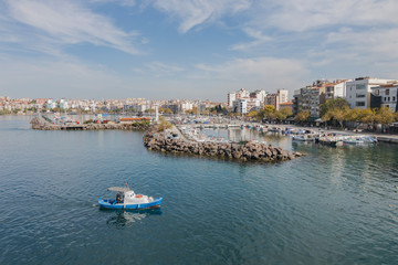 Fototapeta na wymiar Canakkale, Turkey - October 15, 2017: A boat leaves harbor of Gallipoli Canakkale, Turkey