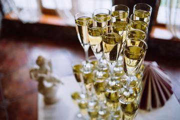 A lot of wine glasses with a cool delicious champagne or white wine at the bar. Alcohol background.