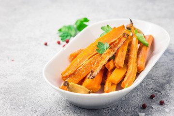 Garlic honey roasted carrots. Selective focus, space for text.