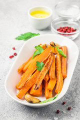 Garlic honey roasted carrots. Selective focus, space for text.