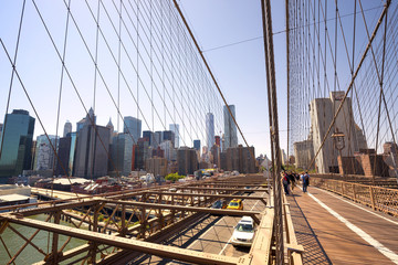 Traffic on the Brooklyn Bridge with the Lower Manhattan skyline in the background, New York, USA