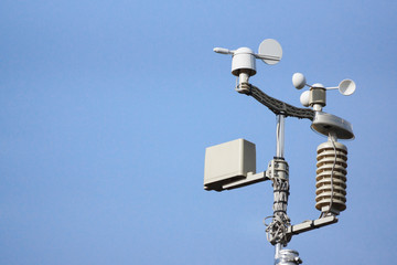 Weather station on blue sky background