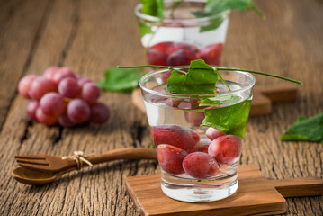 grape fruit with glass on wood