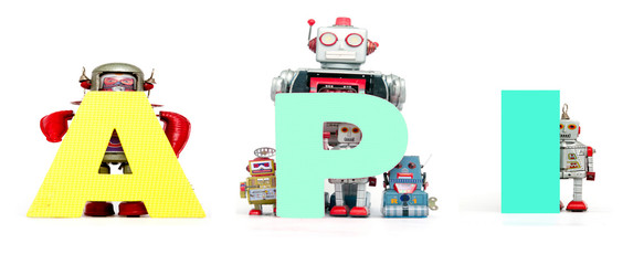 retro tin robot toys hold up the acronym API isolated