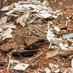 Steel containers with building rubble made of shards of old tiles, bricks, cement and household waste