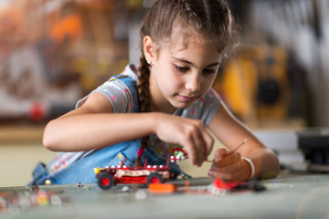 Small girl making a robot
