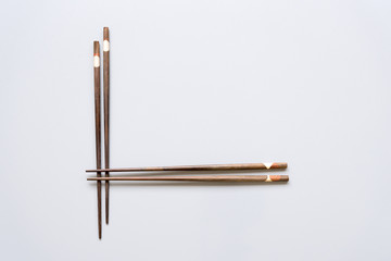 Chopsticks on grey metal background.