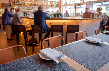Many people having business lunch inside modern cafe or restaurant
