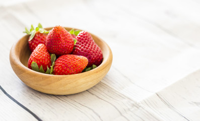 Fresh strawberries close up on wooden background