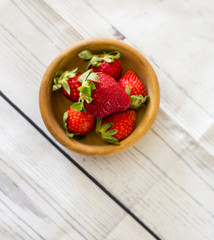 Fresh strawberries close up on wooden background