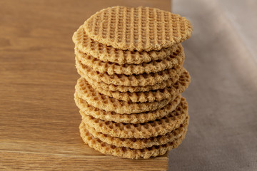 Wafers stacked in a pyramid on a wooden table. Copy space.