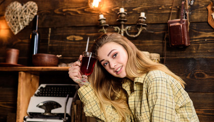 Girl tomboy relax with glass with mulled wine in house of gamekeeper. Relax concept. Lady on happy...