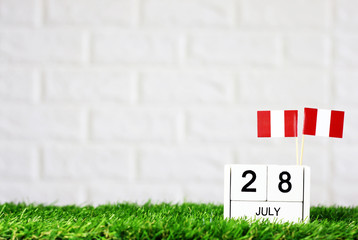 July 28 Wooden calendar and Peru Flag Concept Peru national day with space for your text