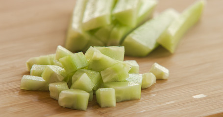 Sliced cucumber on wooden board