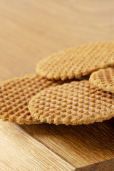 Waffles scattered on a wooden table. Macro. Copy space.