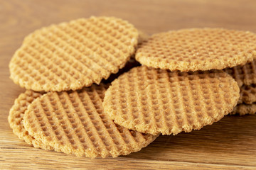 Waffles scattered on a wooden table. Macro. Copy space.