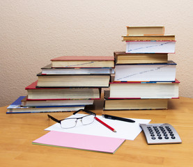 glasses on the background of books and a calculator.