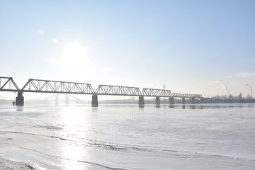 bridge on a frozen river on a sunny day