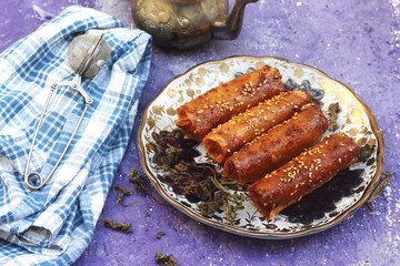  Algerian Almond sweet cigar pastries decorated with sesame and Arabic tea 