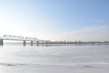 bridge on a frozen river on a sunny day