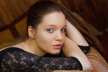 Pretty woman portrait in a cozy comfort housing made of wood in a quiet and pleasant place. Warm tone