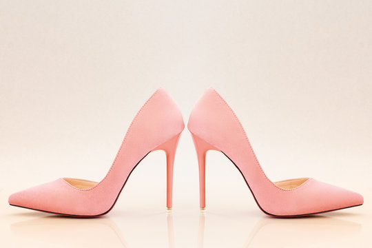 fashionable ladies pink high heels on bright pink background.