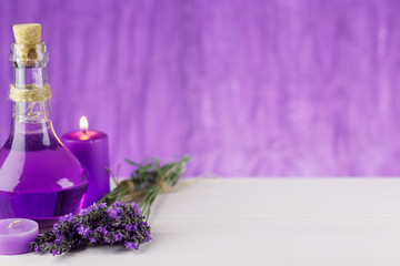 Obraz na płótnie Canvas Spa products, aroma candle and lavender flowers on a wooden background