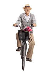 Naklejka premium Mature man riding a bicycle towards the camera
