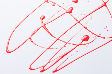 Nail polish on a white background in the form of strips and drops