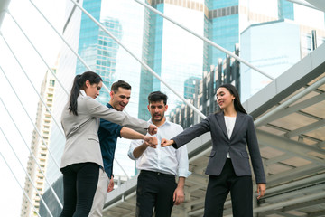 Business people team meeting put their hands together at outdoors. Concept of teamwork, team success, people creative, business people and power of group.