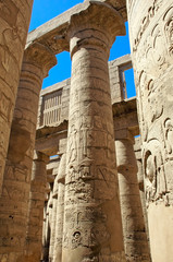 Relief and hieroglyphs on the columns of a large hypostyle temple in Karnak, Egypt