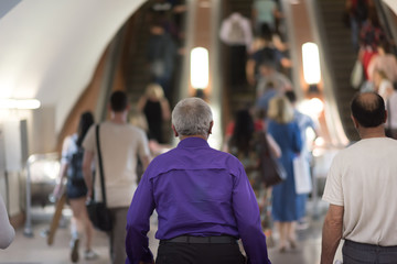 reportage footage of the Moscow metro. Passengers traveling to the escalator. Old man in purple...
