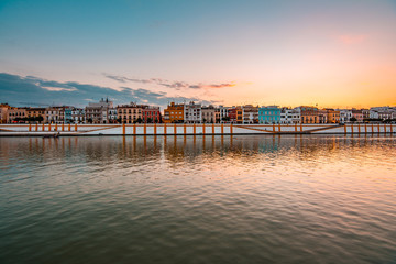 Fototapeta premium Teal and orange view of Guadalquivir river and Triana district in Sevilla, Andalusia, Spain