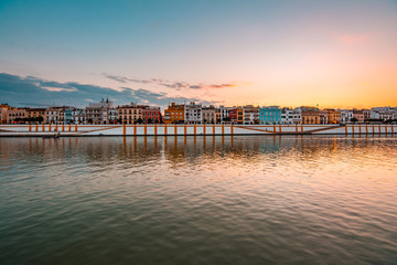 Teal and orange view of Guadalquivir river and Triana district in Sevilla, Andalusia, Spain