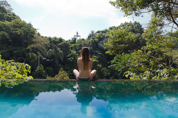 girl in the tropic jungle pool