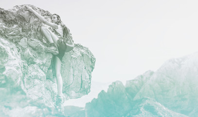 Cold blue toned image of a woman mountain climbing