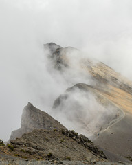 The summit of Mount Meru partly covered by clouds, Tanzania