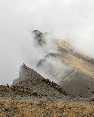 The summit of Mount Meru partly covered by clouds, Arusha National Park, Tanzania